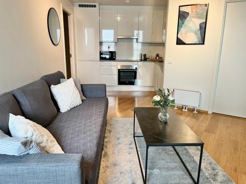 a living room with a couch and a table at SØRENGA Opera, Munch, Fjord & City - Walking distance from Oslo Centralstation in Oslo