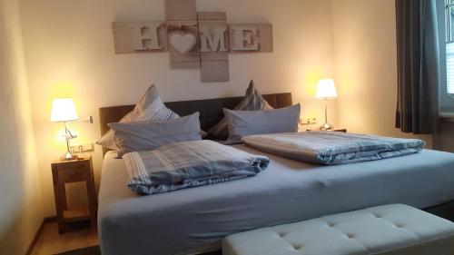 a bed with two pillows on it in a room at Sommerwind am Kurgarten in Willingen