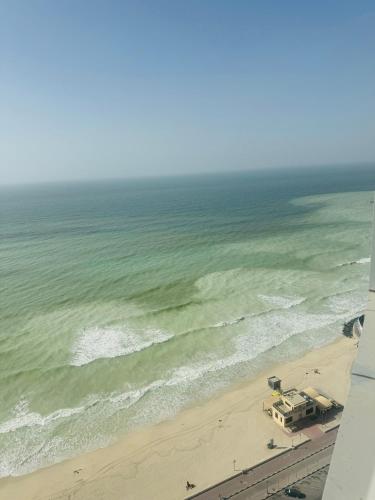an aerial view of a beach and the ocean at Ajman Luxurious Holiday Homes in Ajman 