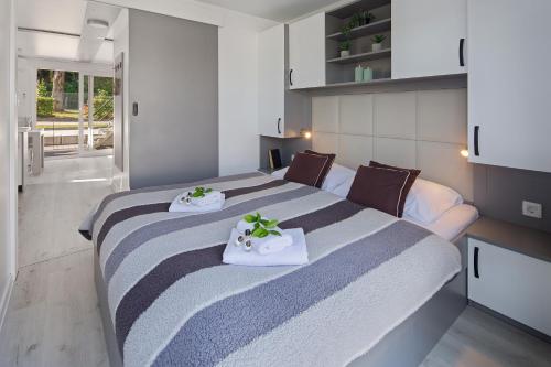 a bedroom with a large bed with two towels at Floating Sea House SHARK 3 in Portorož