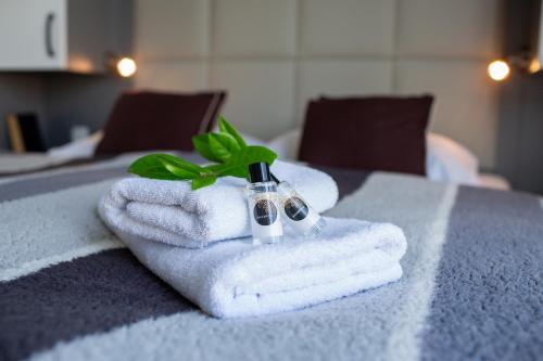 a pile of towels on a table with a green plant at Floating Sea House SHARK 3 in Portorož