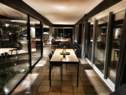 a room with a table and some windows at Casa mARTa : Suites, terrasses et vue panoramique in Tournon-sur-Rhône