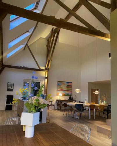 an open living room with a dining room and dining table at Loft en Mar in Irnsum
