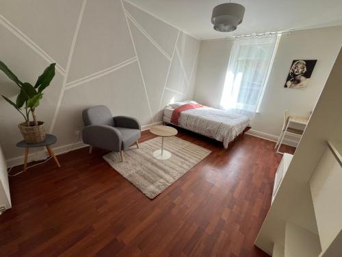 une chambre avec un lit, une table et une chaise dans l'établissement Studio Lux Cattenom Thionville, à Algrange