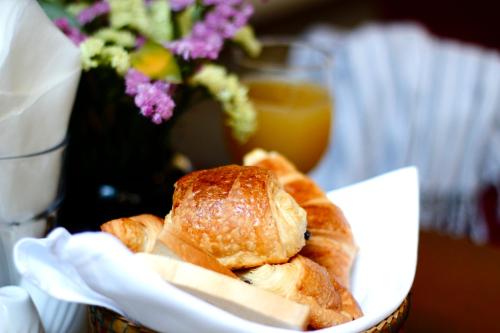 a bowl of bread and cheese on a table with flowers at Cambana d'Angkor Suites in Siem Reap