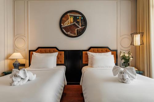 Postel nebo postele na pokoji v ubytování Hadana Boutique Resort Hoi An