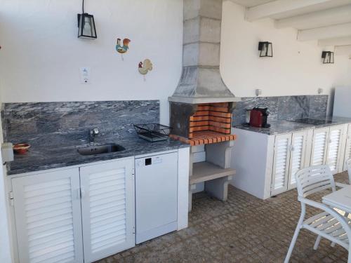a kitchen with a sink and a stove at Monte do Sobreiro in Vimieiro