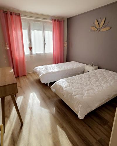 une chambre avec deux lits et une fenêtre dans l'établissement Landon Cottage, à Campénéac