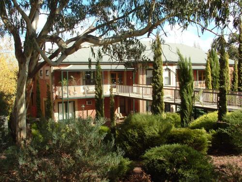 a large red brick building with a balcony at Clare Country Club in Clare