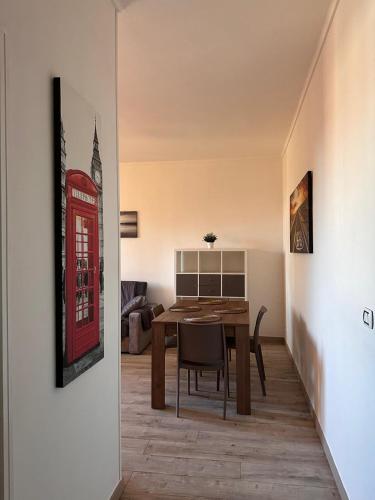 a dining room with a red phone booth on the wall at My HOUSE in Roddino