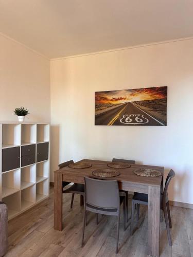 a dining room with a wooden table and chairs at My HOUSE in Roddino