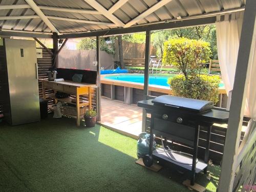 a view of a patio with a pool and a table at VILLA TERRE NEUVE in Signes