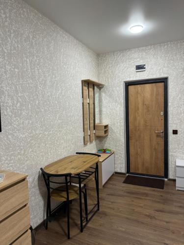 a room with a table and chairs and a door at Family Hotel in Novomoskovsʼk