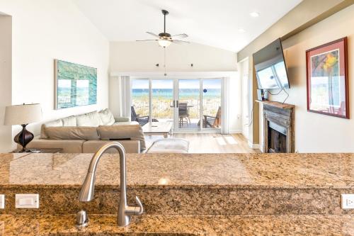 a kitchen and living room with a view of the ocean at Portside Villa, No 36 Pet Friendly Beachfront Paradise Retreat in Pensacola Beach