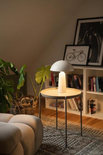 a table with a lamp in a living room at Siedlisko Pozorty in Pozorty