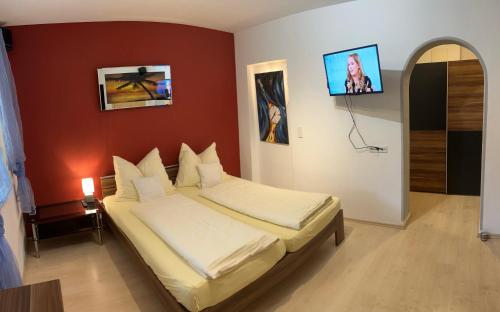 a bedroom with a bed and a tv on the wall at Appartement Christine in Sankt Johann im Pongau