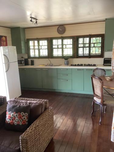 a kitchen with blue cabinets and a couch and a table at Bamboe in Meerzorg