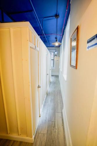 a hallway with blue ceilings and a hallway with a door at Interfaith Retreats in New York
