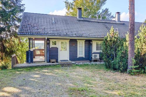 a small blue and white house with a porch at Lomahuoneisto Karkelopirtti 2 B in Himos