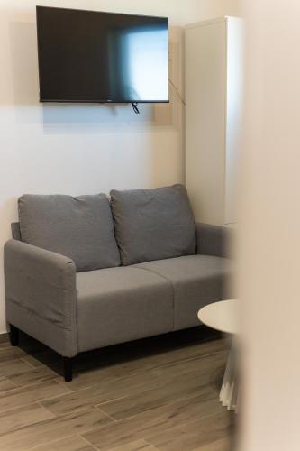 a living room with a couch and a flat screen tv at Sobe za odmor Ema in Bilje