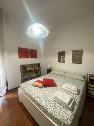 a bedroom with a bed with two towels on it at Appartamento pineta in Viareggio