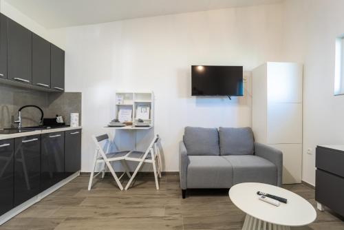 a living room with a couch and a table at Sobe za odmor Ema in Bilje