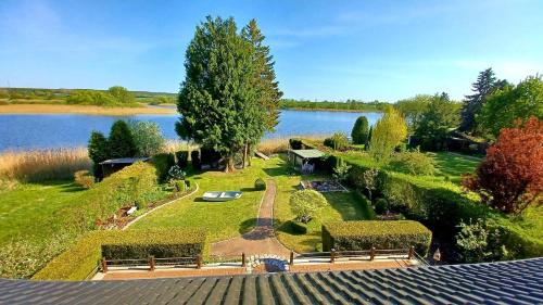 an aerial view of a garden with a lake at Ferienhaus direkt am See in Blankensee
