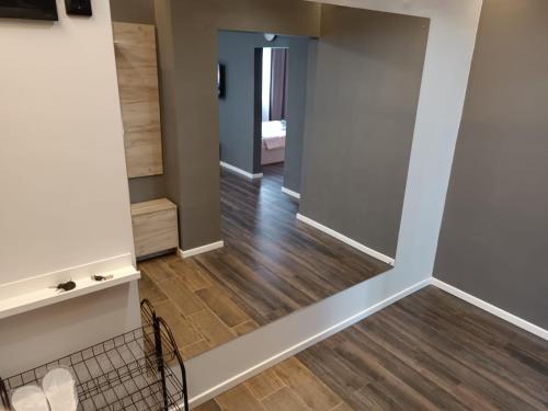 a room with a hallway with wood floors at Евро-VIP ЖК Империя in Kokshetau