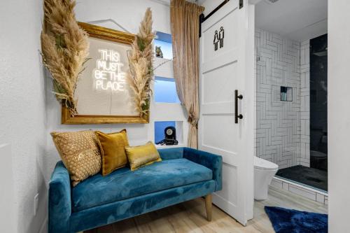 a blue couch in a bathroom with a shower at The Martin Frisco Stay & Play Hot tub, Pool & Firepit in Frisco