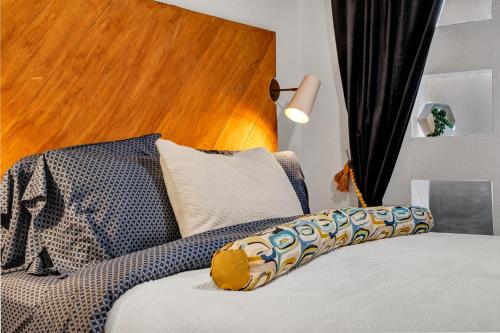 a bedroom with a bed with a wooden head board at The Martin Frisco Stay & Play Hot tub, Pool & Firepit in Frisco