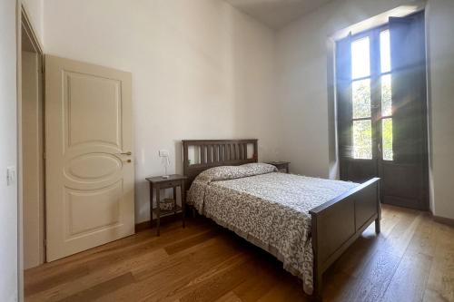 a bedroom with a bed and a window at La CASA al CENTRO in LʼAquila