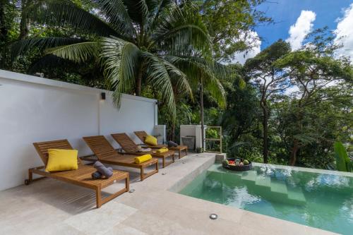 a patio with benches and a swimming pool at Patong 180-degree stunning sea view modern 3-bedroom villa pool stunning sunset BBQ in Patong Beach