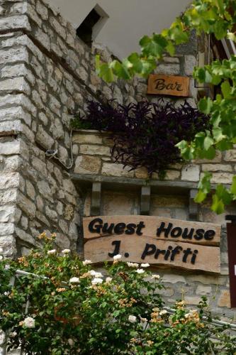 a sign on the side of a stone building at Guest House J.Prifti in Berat