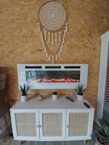 a white cabinet with a fish tank on a wall at Le Clos FMR Insolite - "F"anny Carcassonne in Malves-en-Minervois