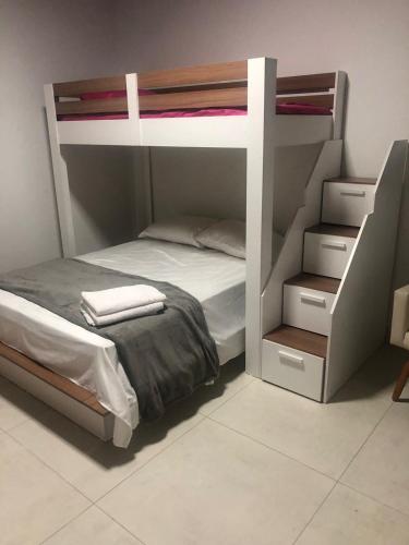 a bedroom with a bunk bed with two tiers at Quarto 03 in Sinop