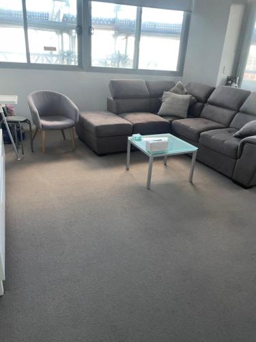 a living room with a couch and a coffee table at Ocean view 2 Bedroom apartment in Sydney