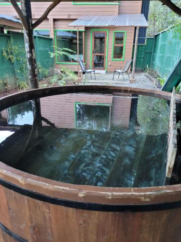 a barrel garden with a house in the background at La Rueda del Chucao in Valdivia