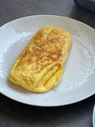 a puff pastry on a white plate on a table at nautilus b&b suite design in Follonica