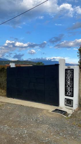 a black and white fence with a black gate at Boskoso in Pereira