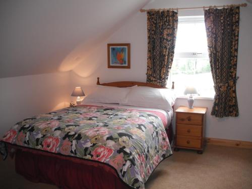 a bedroom with a bed and a window at Killyliss Country House B&B in Lisnalong