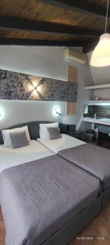 a bedroom with a large bed in a room at olivegrove in Sidari