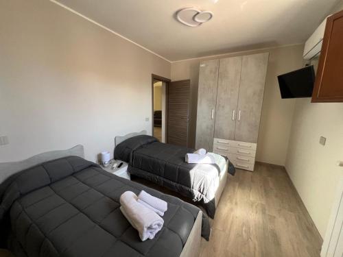 a bedroom with two beds and a couch in it at Casa Vacanza da Patty in San Rufo