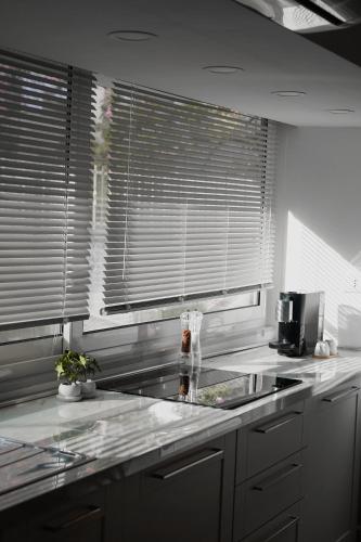 a kitchen with a sink and a counter top at La Perla Apartment in Taranto