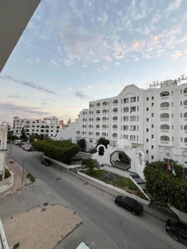 - une vue sur une rue avec un grand bâtiment blanc dans l'établissement La Merveille de la côte à Monastir, à Monastir