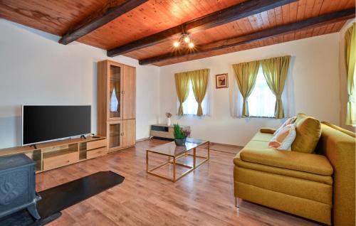 a living room with a couch and a flat screen tv at 1 Bedroom Cozy Home In Blaskovec in Blaškovec