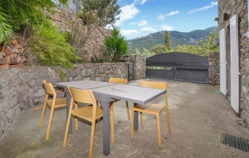 a wooden table and chairs on a patio at 1 Bedroom Lovely Apartment In Vivario in Vivario