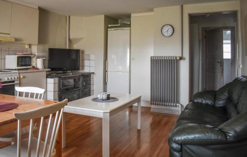 a living room with a couch and a table at Gorgeous Home In Tomelilla With Wifi in Tomelilla