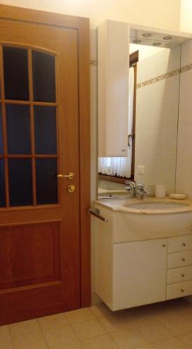 a bathroom with a sink and a mirror at Residenza Al Capitello in Ceniga
