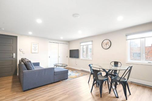 a living room with a couch and a table and chairs at Fancy 3 BDR in Heart of Plateau B in Montréal