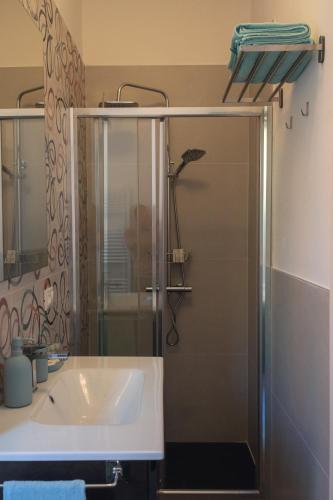 a bathroom with a sink and a shower at Vikos Lodge Apartment in Bologna